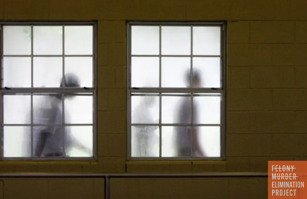 two incarcerated juveniles behind frosted windows in a youth facility