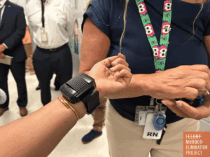 Nurse Lynda Witkowski, who runs the wristband biometric monitoring program at the Curran-Fromhold Correctional Facility in Philadelphia, attaches the device to a reporter’s arm. (Photo: Peter O'Dowd/Here & Now)