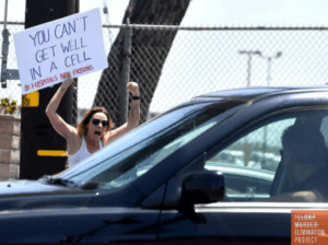 Photo: Demonstrator outside of California Institution for Women (CIW) in Corona CA, holds a sign that says "You can't get well in a cell" (Photo: Will Lester/ Inland Valley Daily Bulletin)